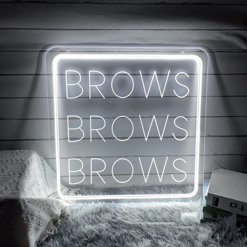 Brows Brows Brows Neon, Neon sign, Beauty salon decor, Eyebrow shaping, Brow-centric salon, Vibrant lighting, Stylish ambiance, Illuminated sign, Trendy neon sign, Chic beauty studio, Salon atmosphere, Brow artist pride, Eyebrow obsession.Trendy, Chic, Glamorous, Stylish, Bold, Eye-catching, Fashionable, Sophisticated, Vibrant, Iconic, Striking, Unique, Sleek, Modern, Alluring,