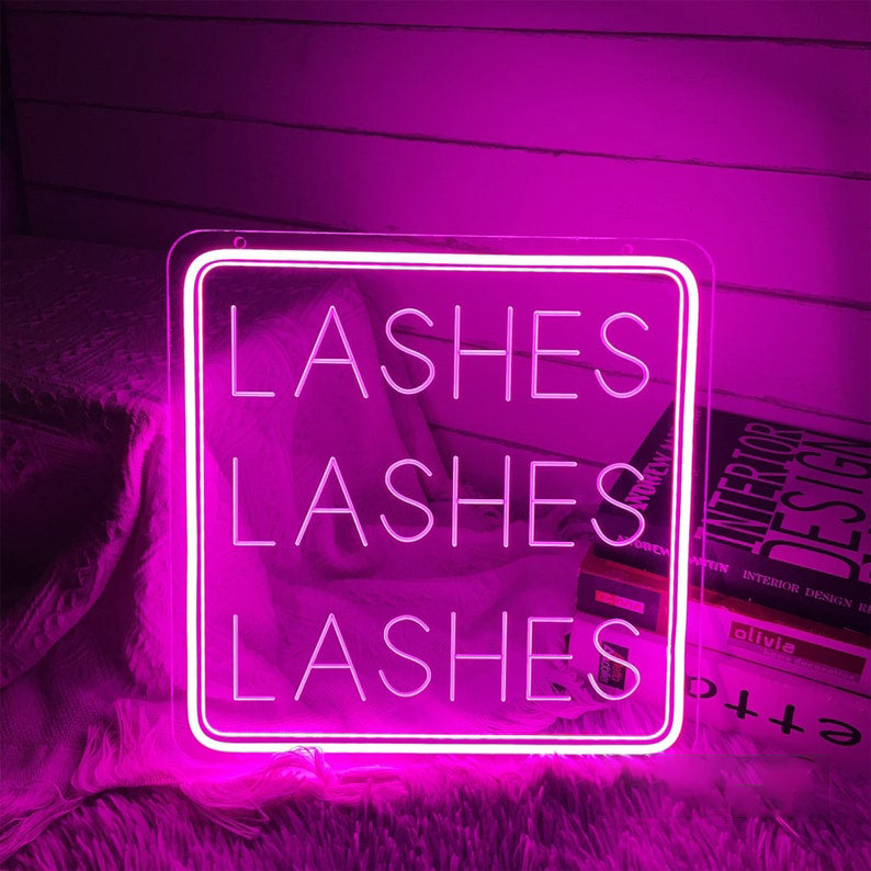 Lashes Lashes Lashes Neon, Neon sign, Beauty salon decor, Eyelash extensions, Lash-centric salon, Vibrant lighting, Stylish ambiance, Illuminated sign, Trendy neon sign, Chic beauty studio, Salon atmosphere, Lash artist pride, Eyelash obsession.